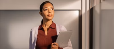 Confident women holding a laptop.