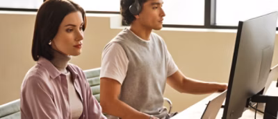 A women and a man working on desktop.