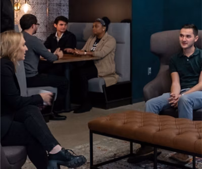 A group of people sitting in chairs.