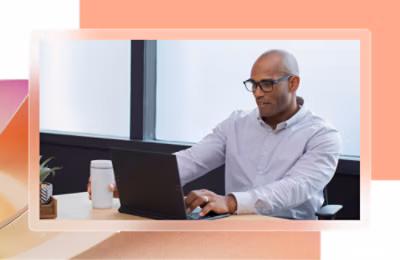 A person sitting at a table using a laptop.