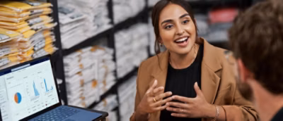 Two people discussing something using a laptop
