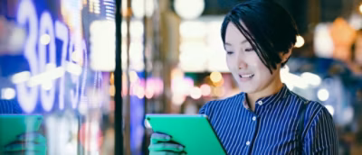 A person in blue shirt looking at a tablet