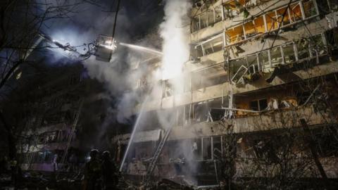Ukrainian rescuers work at the site of a Russian air strike on a residential building in Kyiv. Photo: 14 October 2026