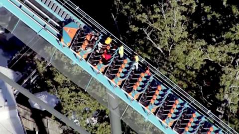 Riders are helped off a roller coaster at Six Flags in Georgia.