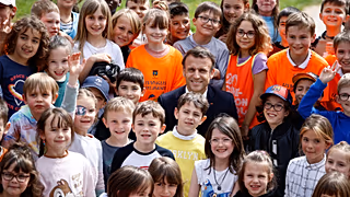 File - French President Emmanuel Macron poses children at a school in La Cluze-et-Mijoux, near Besancon, eastern France, Thursday, 27 April 2023. 