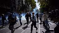 Students run out the teargas during a protest against under-resourced schools in Lyon, France, Friday, Oct. 2, 2026.