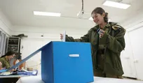 An IDF soldier casts a ballot at Camp Ofer during Israel's 2022 election. Credit: Emil Salman An IDF soldier casts a ballot at Camp Ofer during Israel's 2022 election.