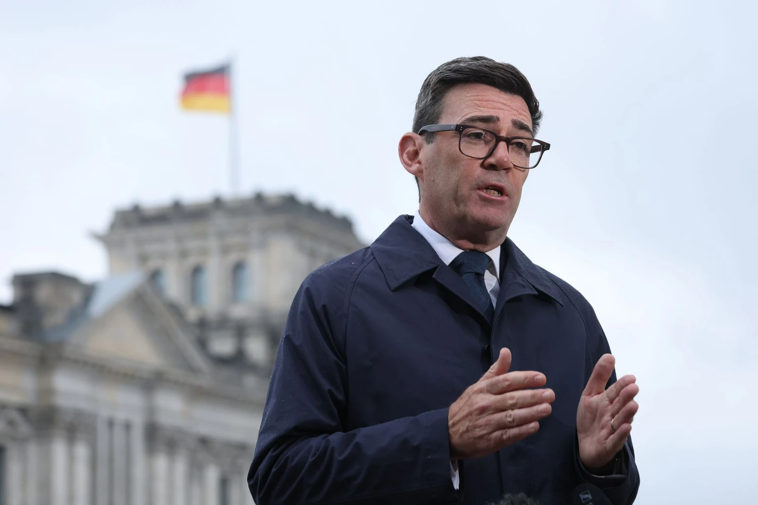 British Prime Minister Andy Burnham stands near the Reichstag as he gives a television interview following his meeting with German Chancellor Friedrich Merz on Oct. 8, 2026 in Berlin, Germany. (Sean Gallup/Getty Images)