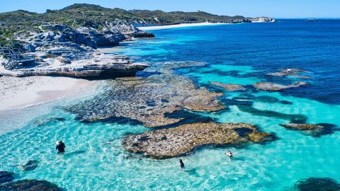 Aerial shots of the turquoise water, reef formations, beach and shipwreck at Henrietta Rocks.
