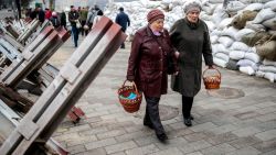 Faithful walk between sandbags and hedgehog anti-tank barricades to attend a blessing of traditional Easter food baskets on Holy Saturday, amid Russia's invasion of Ukraine, in Zhytomyr, Ukraine April 23, 2022. REUTERS/Viacheslav Ratynskyi TPX IMAGES OF THE DAY