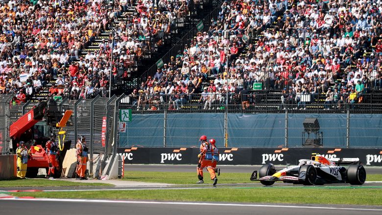 MEXICO CITY, MEXICO - OCTOBER 26: Marshals run as Liam Lawson of New Zealand driving the (30) Visa Cash App Racing Bulls VCARB 02 approaches on track during the F1 Grand Prix of Mexico at Autodromo Hermanos Rodriguez on October 26, 2025 in Mexico City, Mexico. (Photo by Hector Vivas/Getty Images)