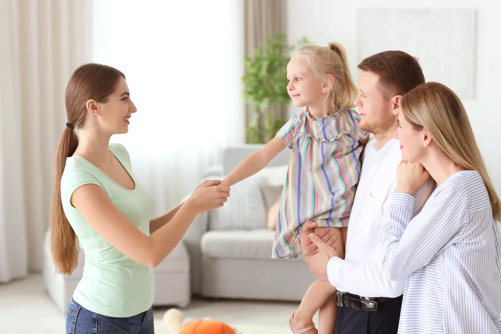 Parents leaving their daughter with a nanny at home.