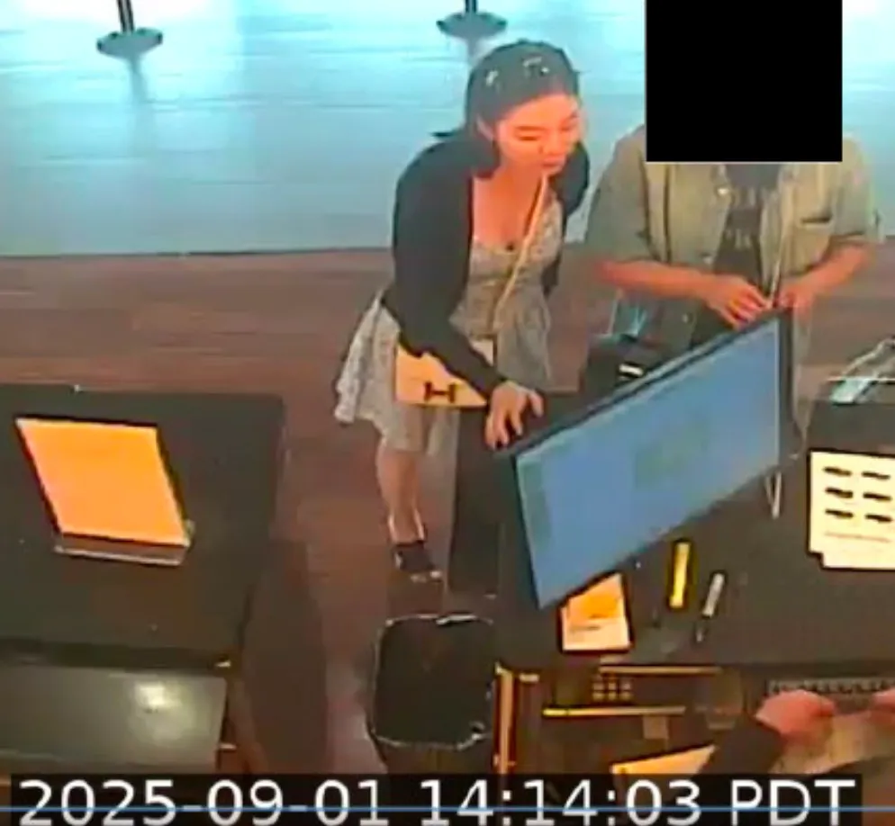 Surveillance camera image of Wanying Zhang, also known as "Heather," standing at a counter.