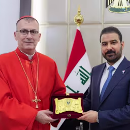Iraqi Prime Minister Ali al Zaidi, right, receives Chaldean Patriarch Mar Paul III Nona. | Credit: Iraqi prime minister’s media office