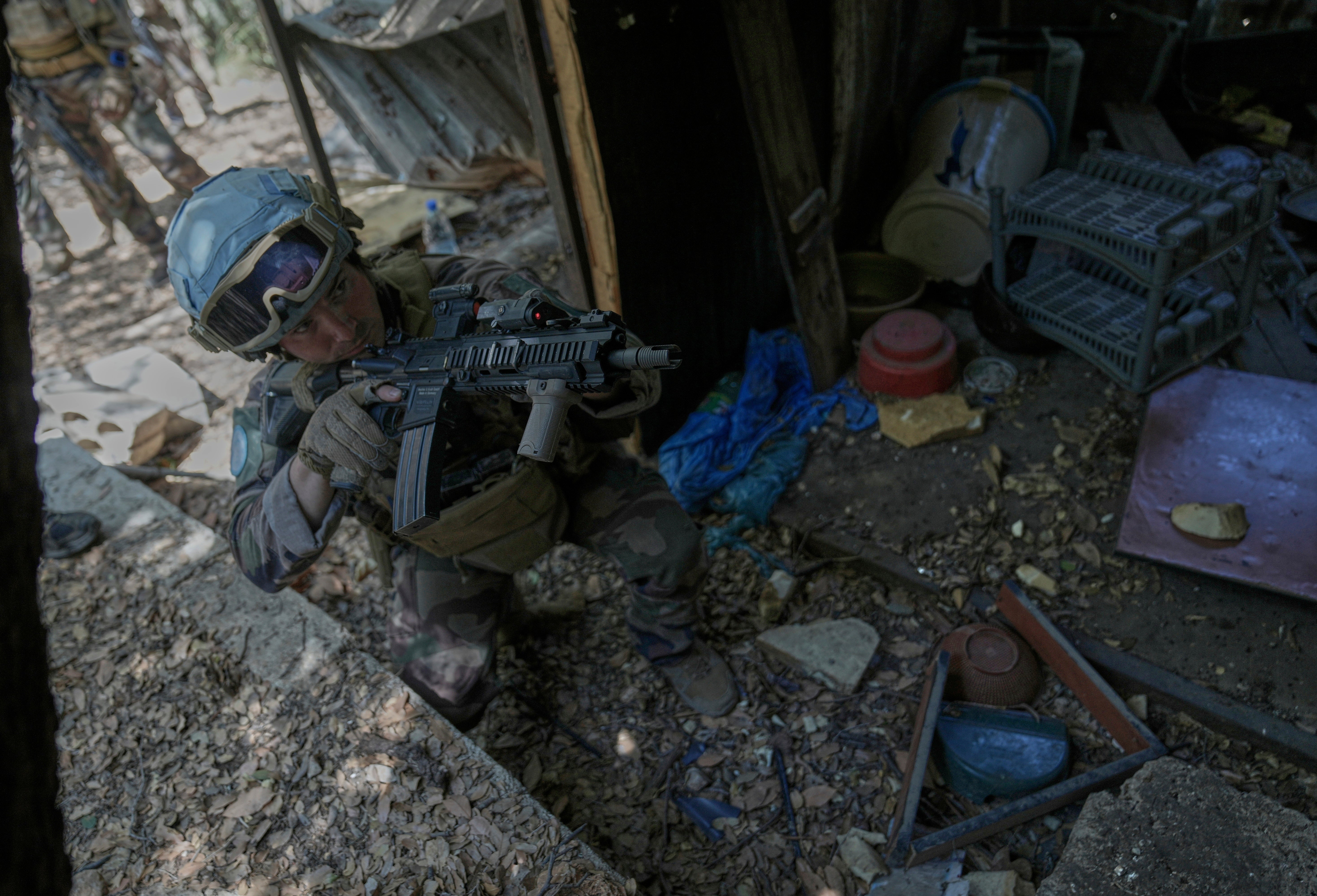 A French peacekeeper inspects a position recently held by Hezbollah forces in south Lebanon, August 2025.