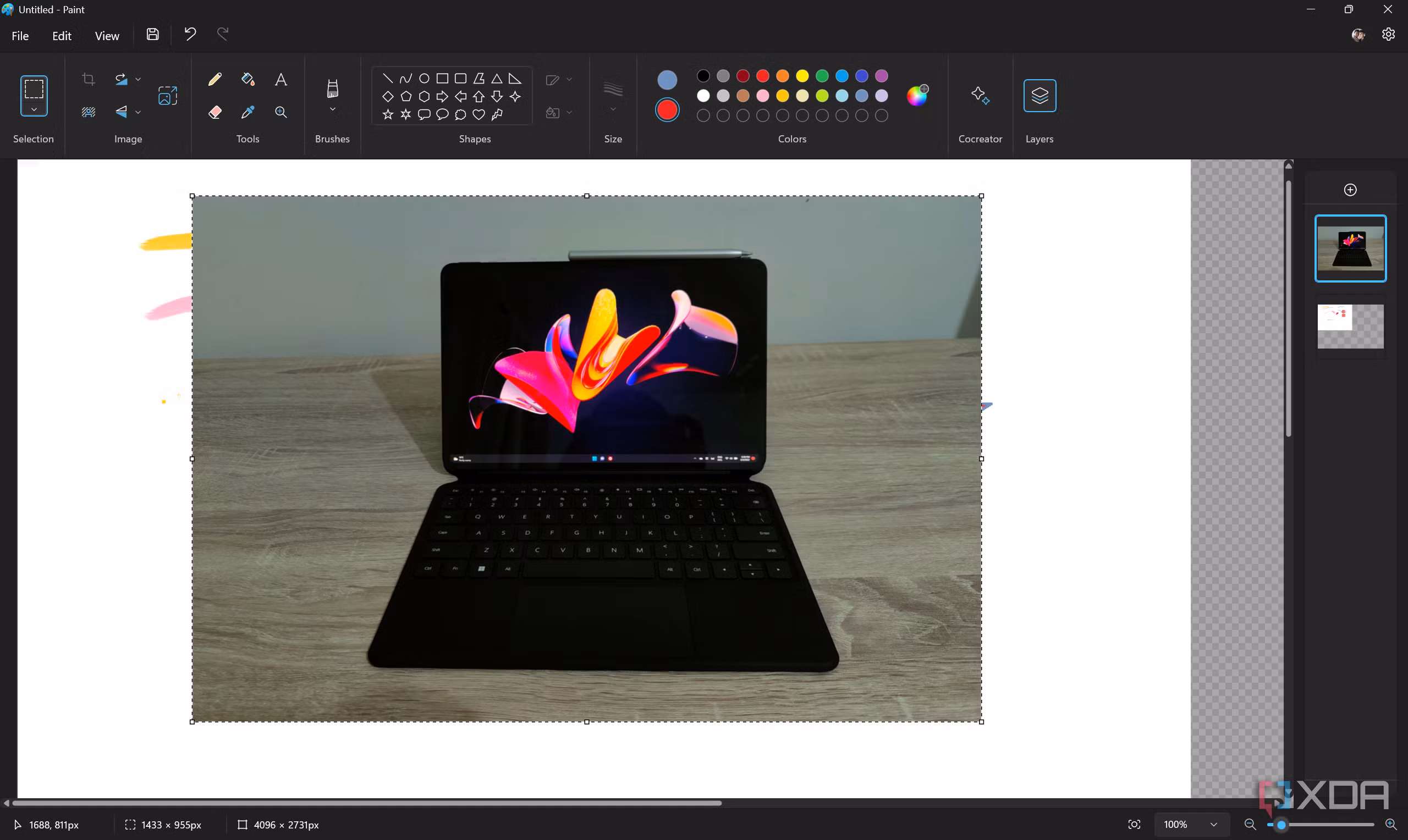 Screenshot of the Paint app in Windows 11 with a layer with a photo of a tablet open on a second layer