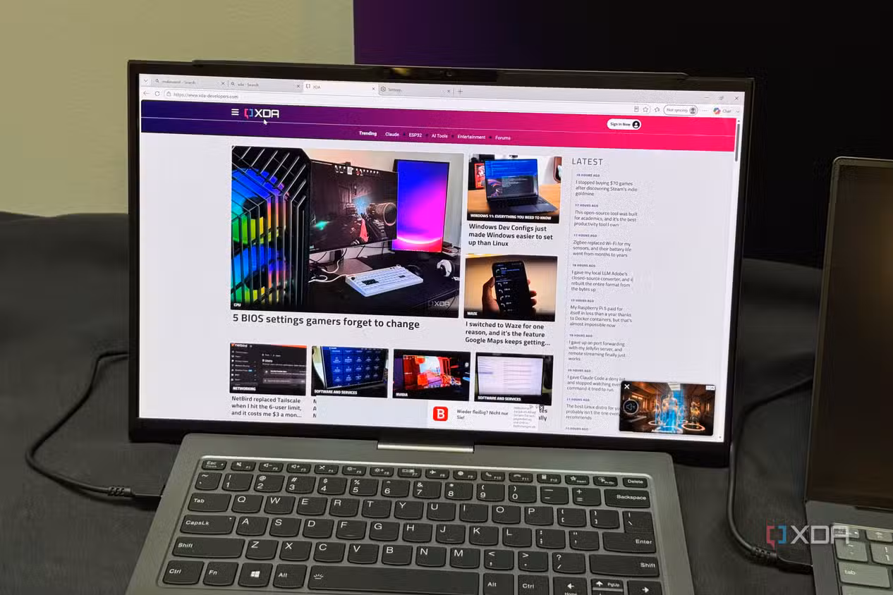 ThinkBook Project Swan with its display rolled out, XDA homepage filling the tall screen