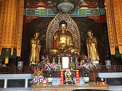 Temple with Buddha image, flanked by Ānanda and Mahākāśyapa