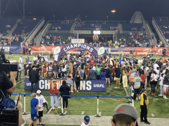 Celebrations taking place with the winning team receiving the trophy on the championship podium.