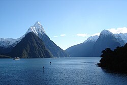 Blue water against a backdrop of snow capped mountains