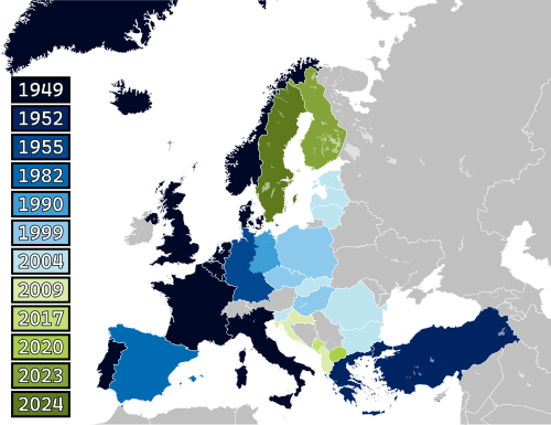 A map of Europe with countries labelled in shades of blue, green, and yellow based on when they joined NATO.