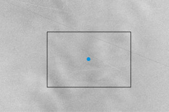 A grayscale polarimetric photograph of the L5 Kordylewski cloud, with dark streaks representing denser areas