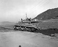 B Company tank retriever moves back up onto road after by passing bridge on road to Hamhung, 10 Nov 1950.