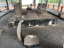 A rectangular stone tomb where the stones are held in place with cement