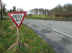 Irish-language road sign on a road junction in Baile Ghib