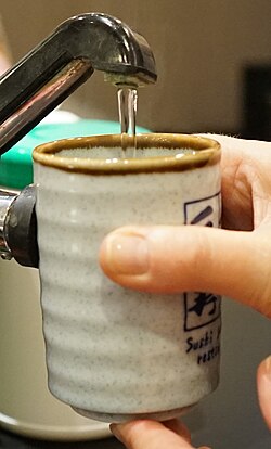 Pouring just-boiled water into a ceramic mug. Steeping menstrual cups is very effective.