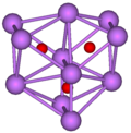 The stick and ball diagram shows three regular octahedra which are connected to the next one by one surface and the last one shares one surface with the first. All three have one edge in common. All eleven vertices are purple spheres representing caesium, and at the center of each octahedron is a small red sphere representing oxygen.