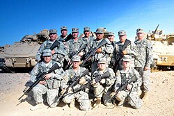 California State Military Reserve troops armed with M16s with 3 Bradleys behind them took a photo while undergo Base Security Training.