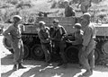 Members of the 389th Infantry Regiment, 2d Infantry Division, help a veteran of the battle of "Old Baldy" into the forward aid station for treatment after transport by an M39 Armored Utility Vehicle, Korea, 19 September 1952.