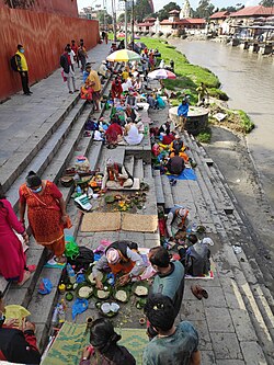 People performing shraddha on the banks of Bagmati river near Pashupatinath temple, Nepal