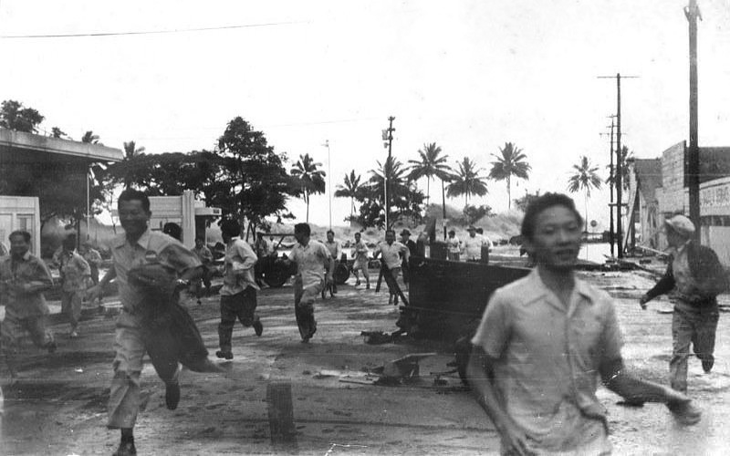People run from an approaching tsunami in Hilo, Hawai'i, on 1 April 1946; note the wave just left of the man's head in right center of image.