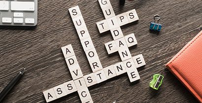 Scrabble pieces depicting words of support, guidance, and assistance.