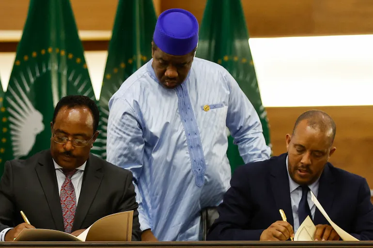 Redwan Hussein (L), Representative of the Ethiopian government, and Getachew Reda (R), Representative of the Tigray People's Liberation Front (TPLF), sign a peace agreement between the two parties during a press conference regarding the African Union-led negotiations to resolve conflict in Ethiopia at the Department of International Relations and Cooperation (DIRCO) offices in Pretoria on November 2, 2022.