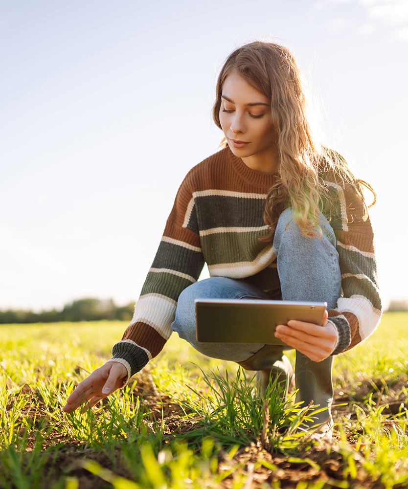 Farmer using iPad for data on field