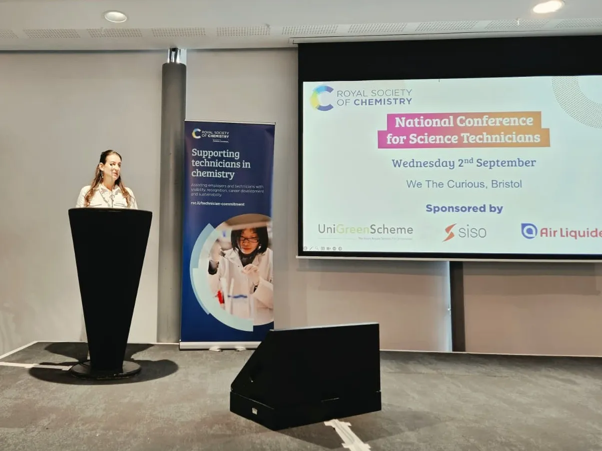 National Conference for Science Technicians 2026 - general event shots (3) Catherine Perry, of the Royal Society of Chemistry, standing at a podium with a screen displaying the words "National Conference for Science Technicians"